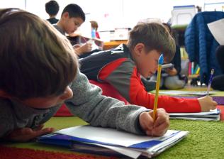 Students writing in school