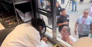 Student takes order out of food truck
